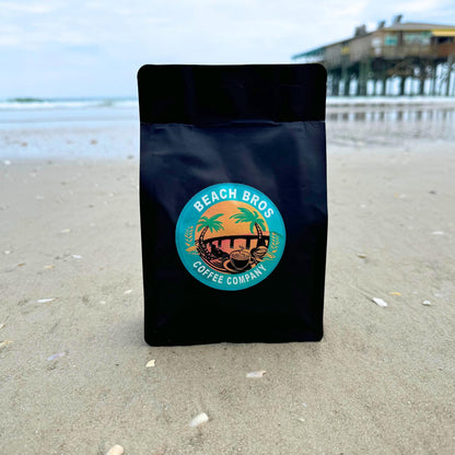 Photo of coffee bag in sand at beach